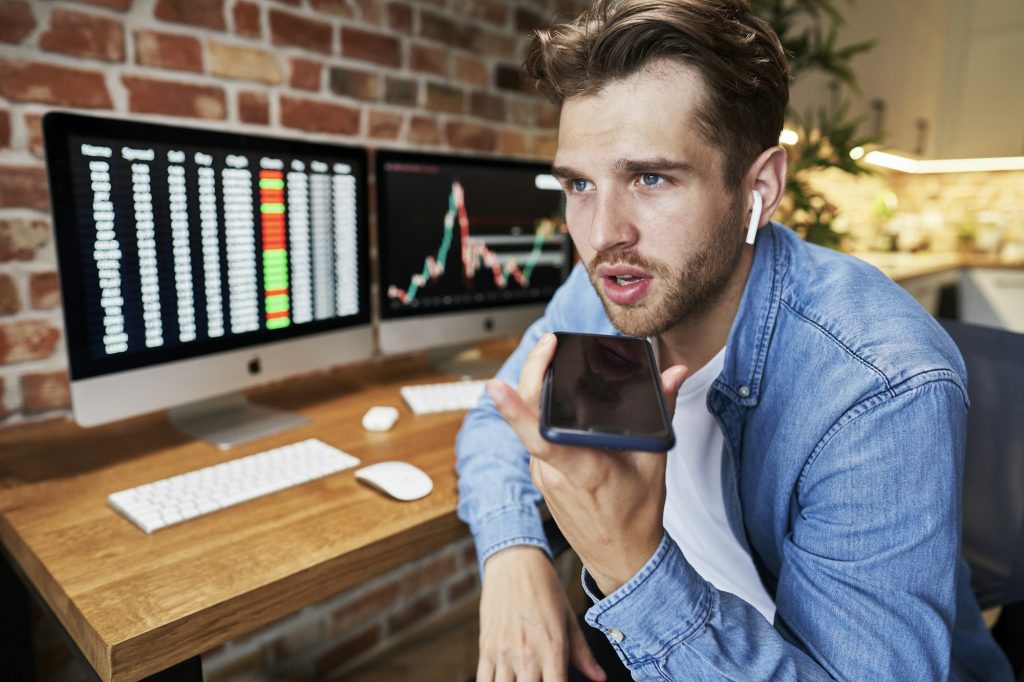 Busy young man talking by mobile phone