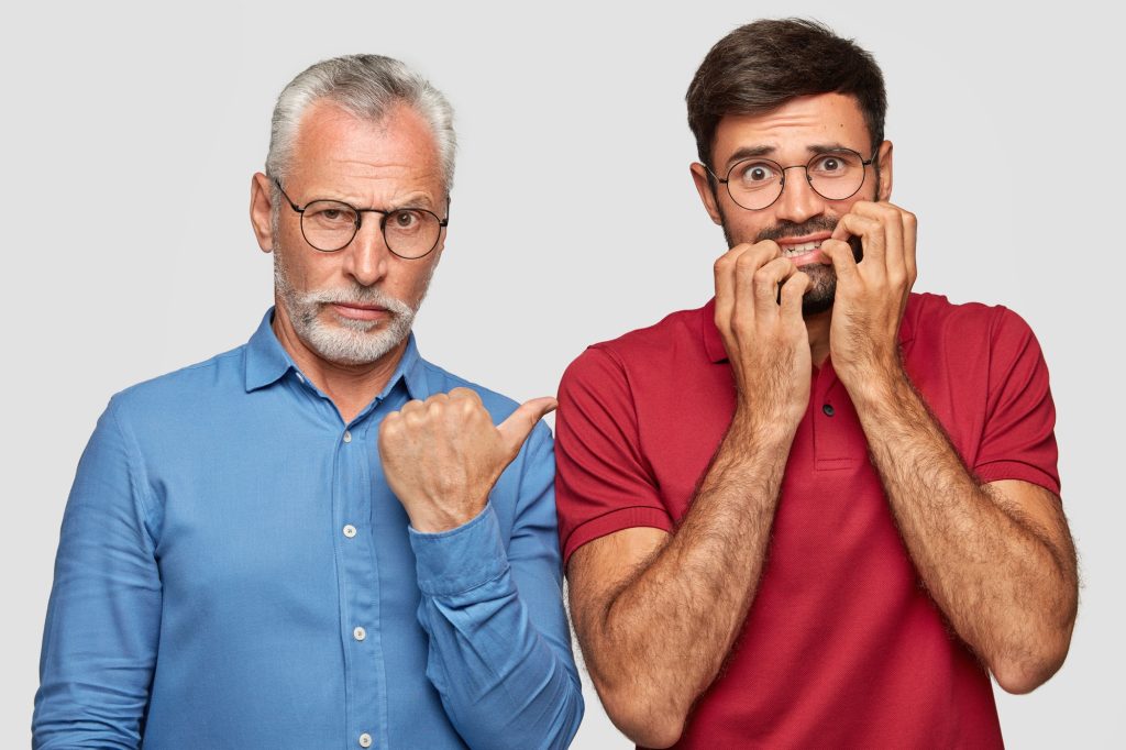 People, affinity, emotions concept. Nervous anxious adult bites finger nails with fear, mature male