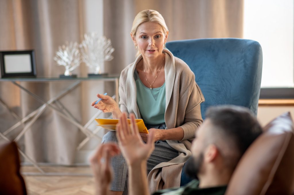 Comment surmonter la dépersonnalisation et la déréalisation : stratégies et conseils Psychologist providing psychological support to a man