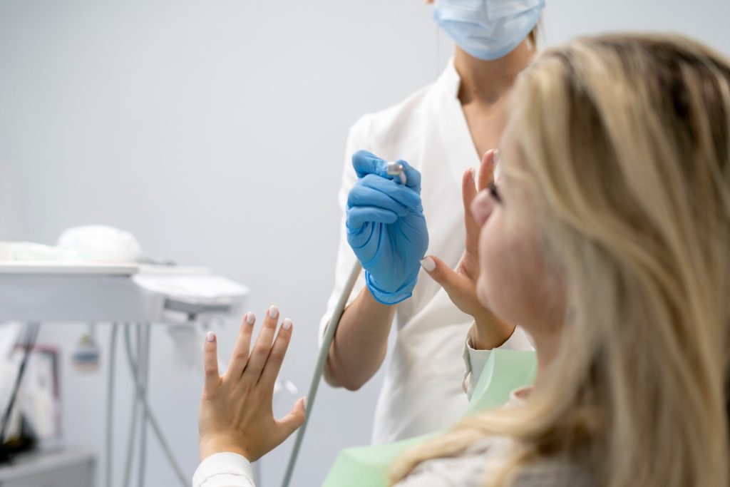 a scared and frightened female patient feels dentist phobia, young girl in panic