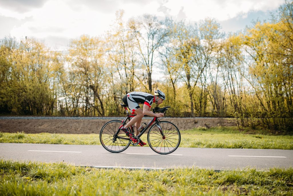 Cyclist rides on bicycle, speed effect, side view