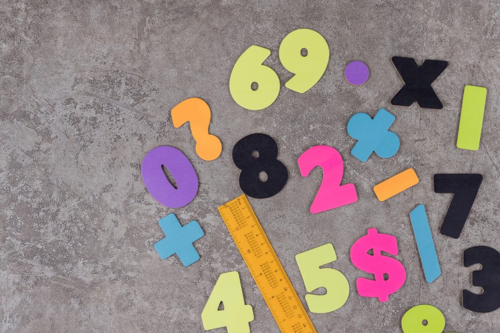 School stationary and numbers on grey background.