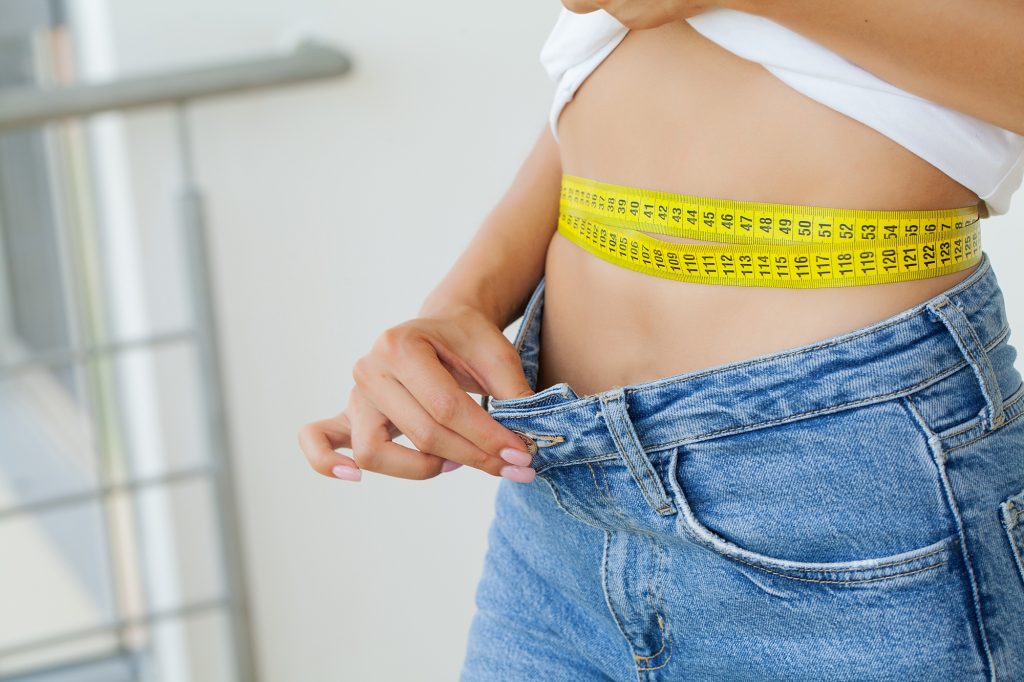 Diet, Sporty Woman Showing How Much Weight She Lost.