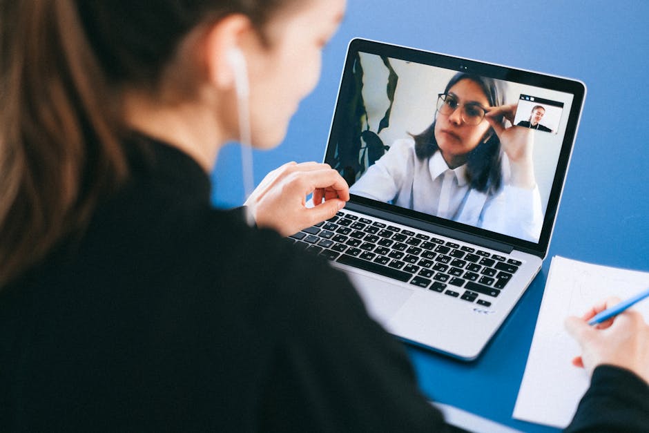 Person looking tired during a video conference call on a laptop