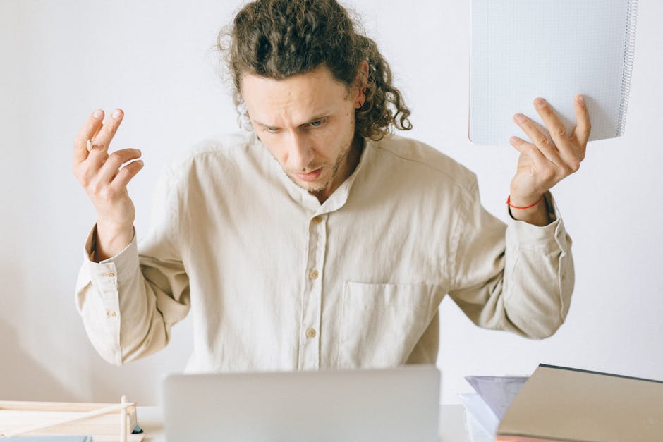 Stressed worker at desk under pressure in a toxic work environment