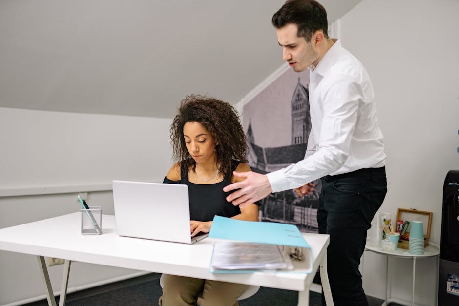 Manager accompagnant un employé dans une formation à l'intelligence artificielle en milieu professionnel