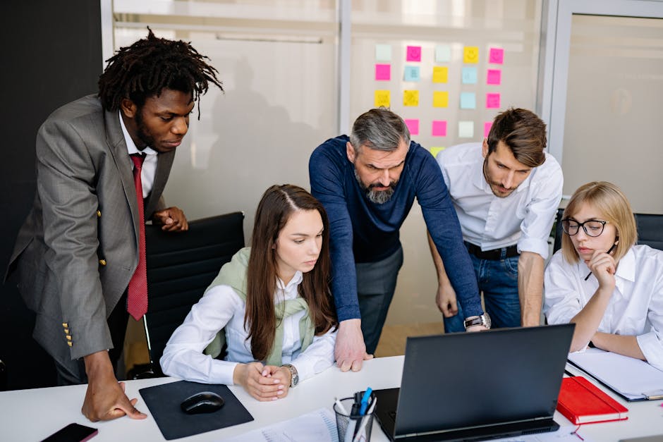 Manager observing and adapting leadership style with team in office