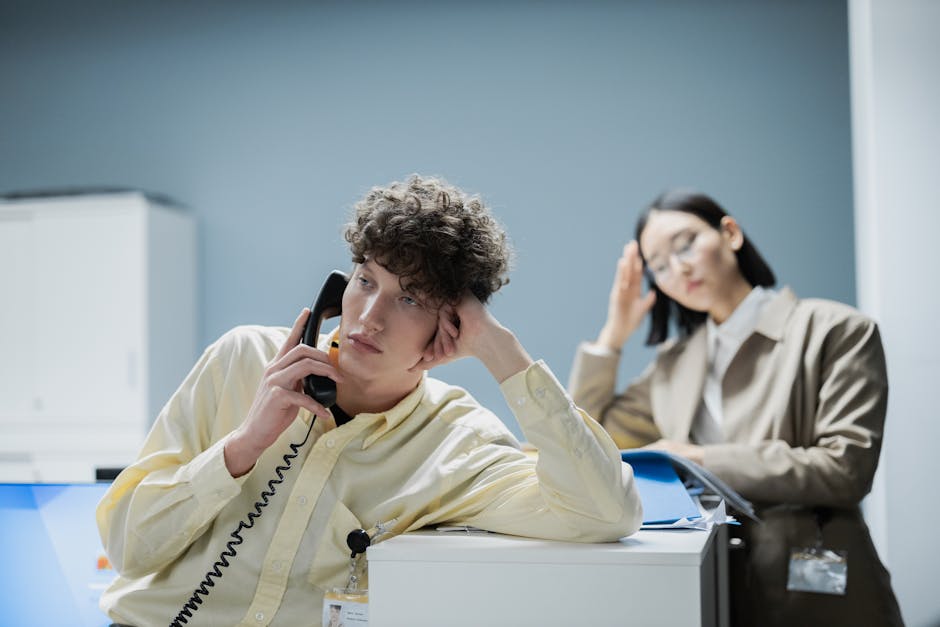 Employee working at a desk with a neutral, disengaged posture in a modern office