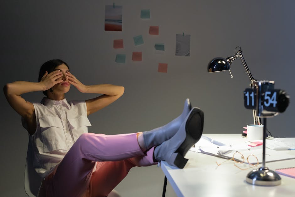 Professional employee practicing deep breathing at desk to manage workplace stress